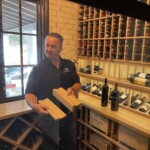 These wooden trays give visual appeal to the custom wine display row.