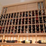 LED lighting highlights this custom wine bottle display row.