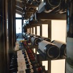 This modern home wine cellar features double-deep metal racking that shows off the bottles beautifully.