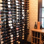 Wooden and metal wine racks go together beautifully in this custom home wine cellar.