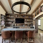 This beautiful custom home bar is watched over by a good boy.